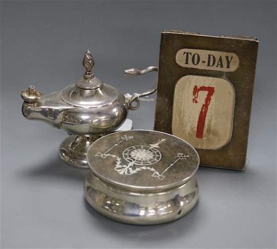 A George V silver and tortoiseshell mounted toilet box, a silver mounted desk calendar and a silver mounted club perpetual lighter.